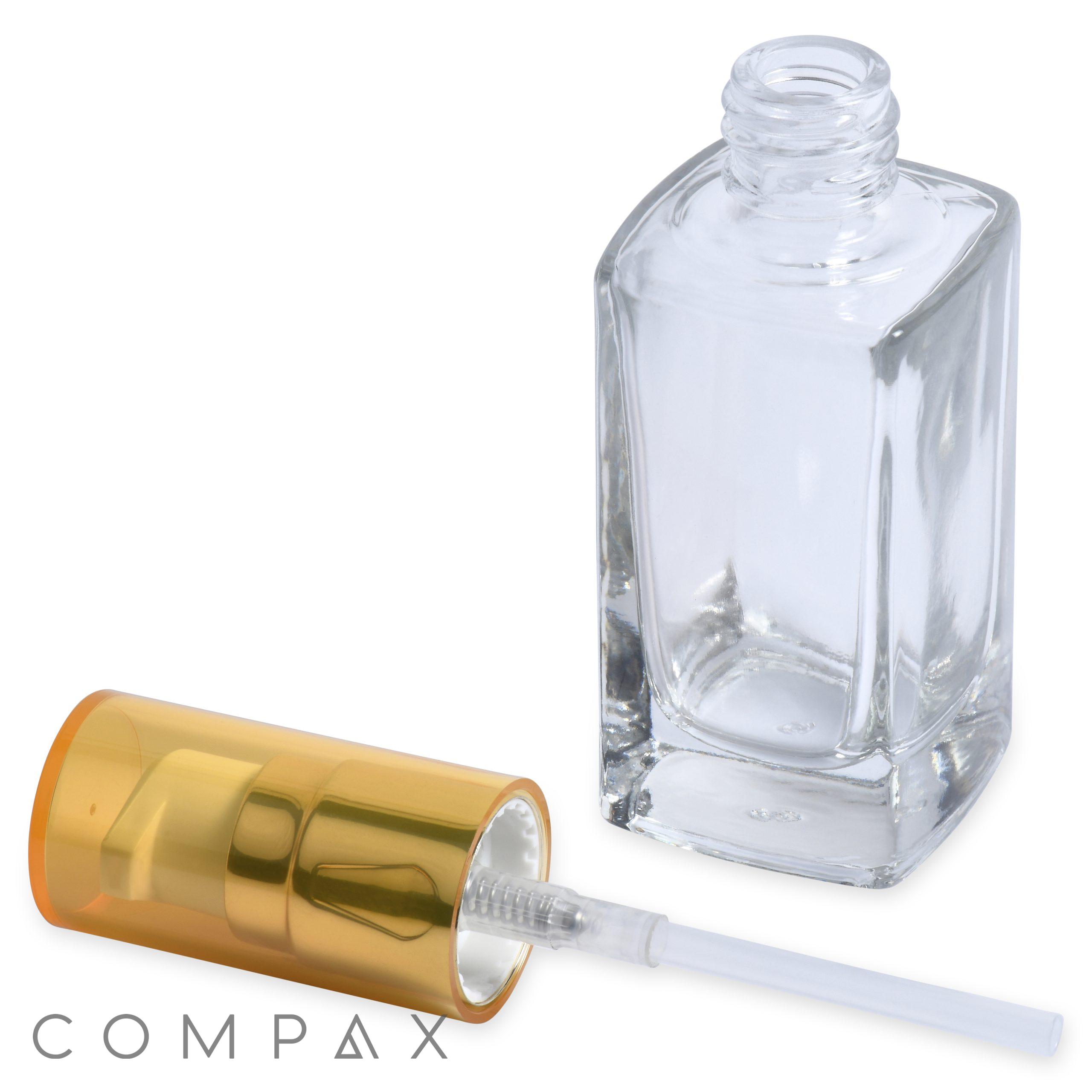 A 30mL Glass Square Bottle stands upright, with an unscrewed golden spray nozzle lying beside it. The brand name "COMPAX" is visible in the bottom left corner of the image.